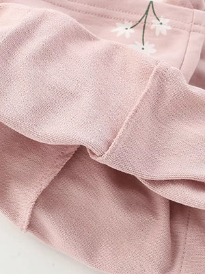 Blush pink cotton blend girls' undershirt with daisy graphic detail and comfortable fit.
