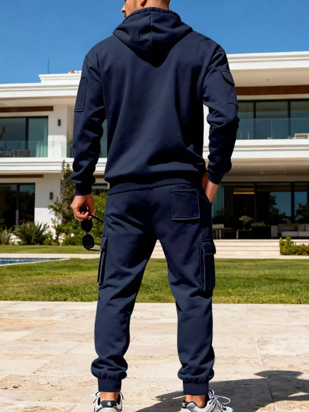 Navy blue men's hoodie and cargo sweatpants set with patch pockets.