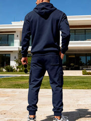 Navy blue men's hoodie and cargo sweatpants set with patch pockets.