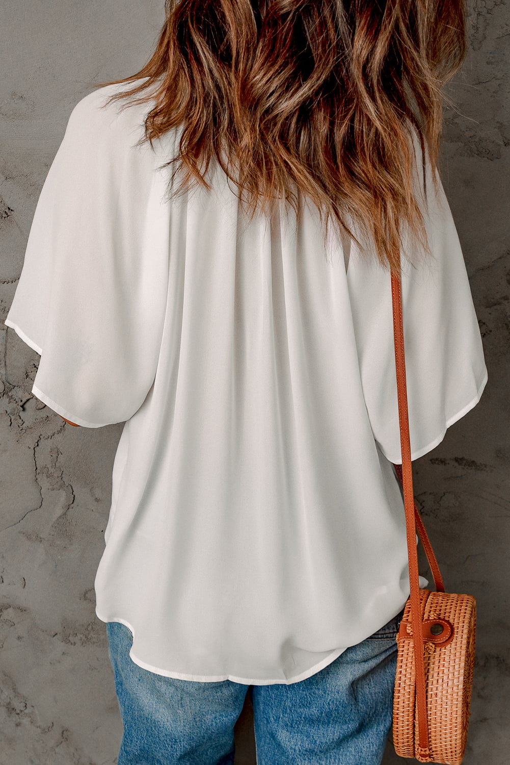White relaxed v-neck blouse with cap sleeves and gathered detail