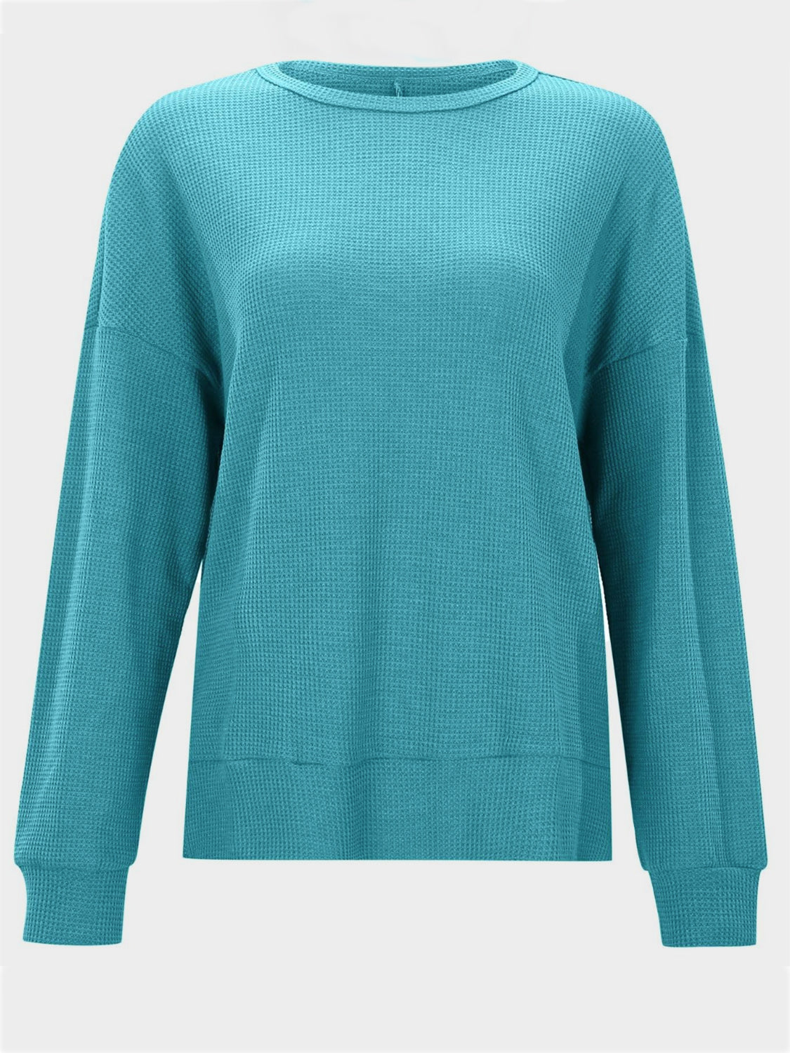 Waffle knit crewneck top in pastel blue with relaxed fit and long sleeves.