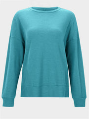 Waffle knit crewneck top in pastel blue with relaxed fit and long sleeves.