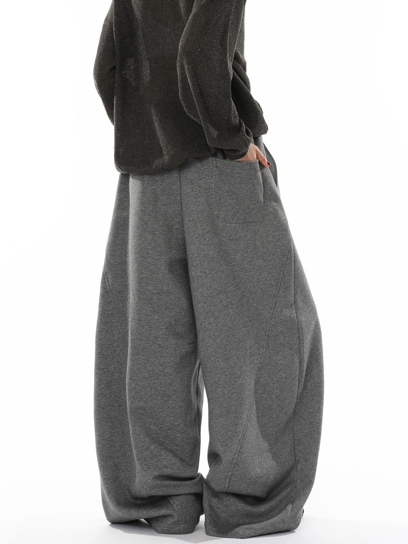 Men's gray wide-leg sweatpants with drawstring waist and pockets.