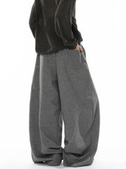 Men's gray wide-leg sweatpants with drawstring waist and pockets.