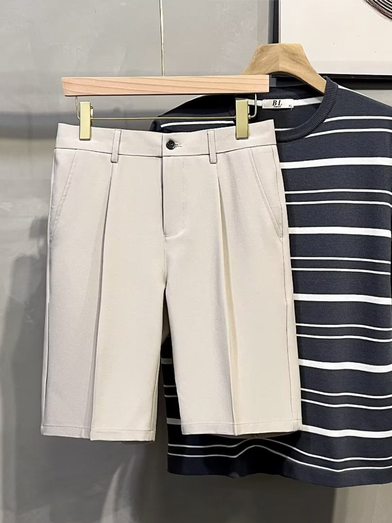 Cream pleated front casual men's chino shorts with a button and zip closure.