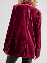 Burgundy velvet double-breasted blazer with patch pockets and button cuffs.