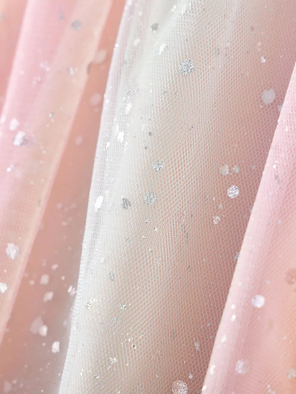Baby dress fabric with pink and white tulle, silver glitter dots, and rainbow heart applique detail.