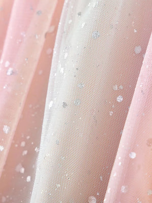 Baby dress fabric with pink and white tulle, silver glitter dots, and rainbow heart applique detail.