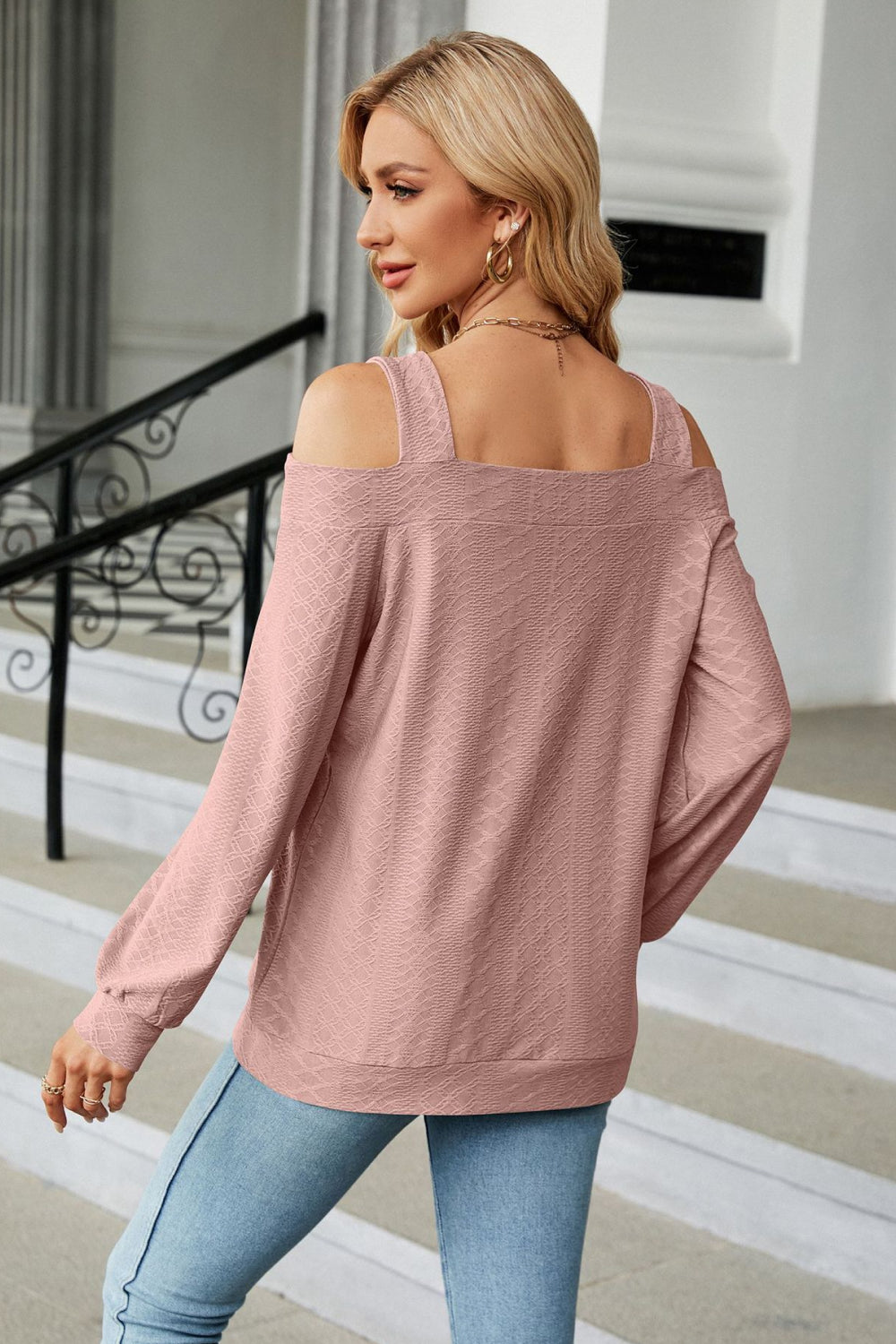 Blush pink textured open shoulder blouse with square neckline and long sleeves.