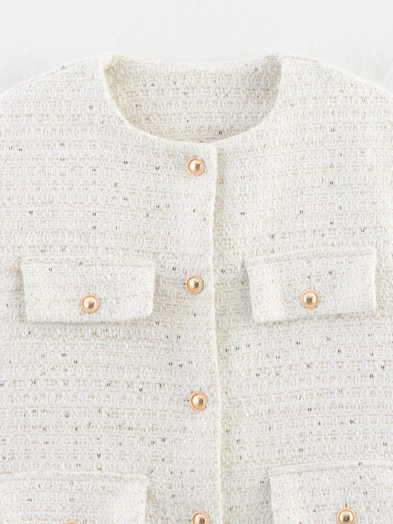 White tweed cropped button-up jacket with gold buttons and pocket details.
