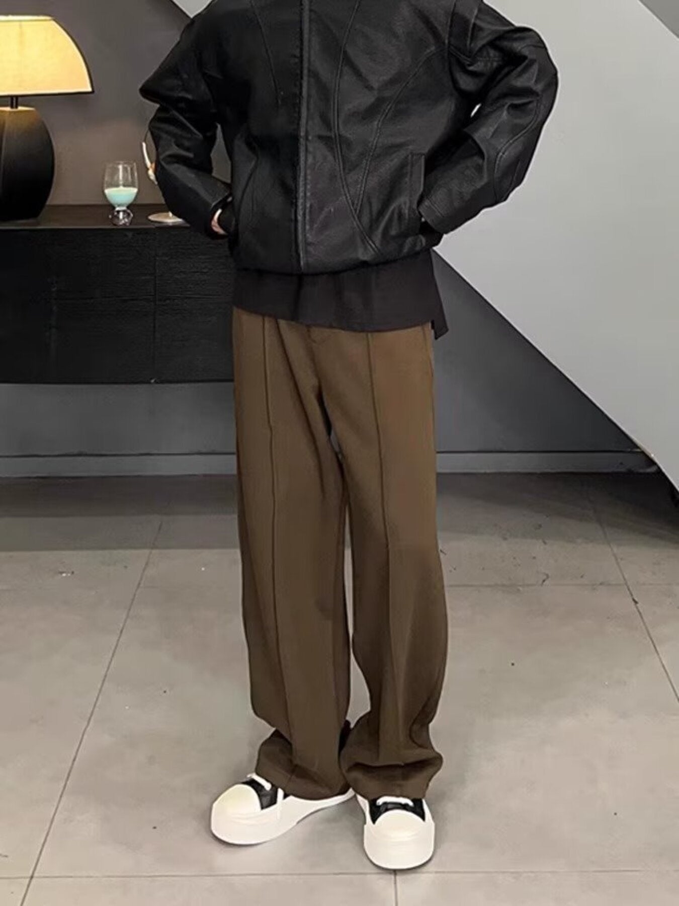 Men's brown relaxed fit wide leg sweatpants with front seam detail.