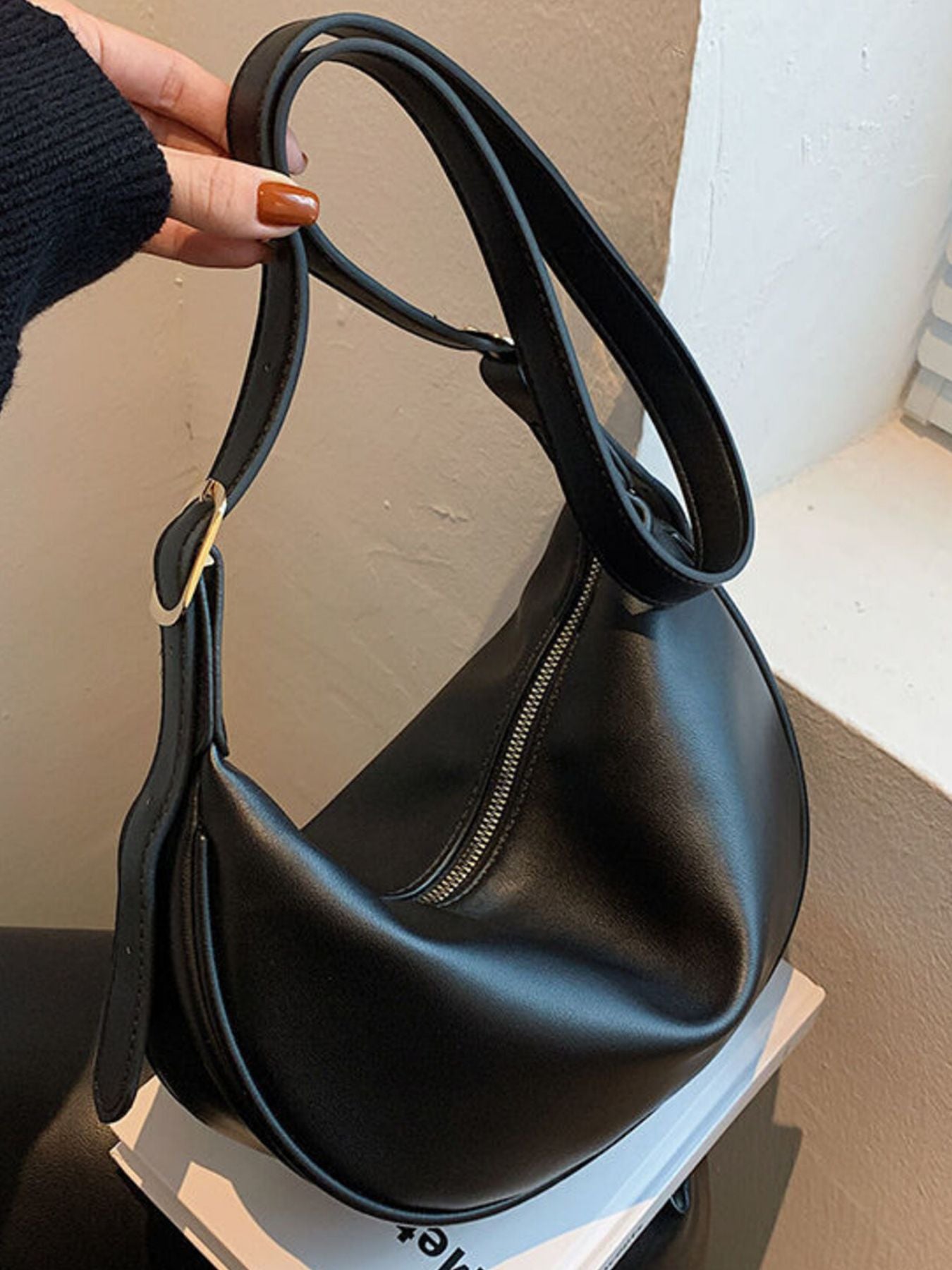 Black pu leather crescent crossbody bag with silver zipper detail