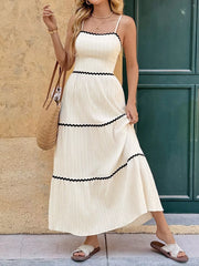 Cream cami dress with scalloped contrast trim and tiered skirt.