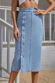 Button-front denim midi skirt in light wash with a side slit and button closure.