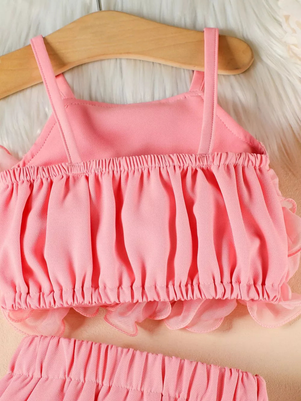 Pink ruffled cami and skirt set with delicate sheer trim.