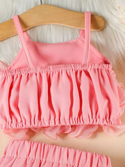 Pink ruffled cami and skirt set with delicate sheer trim.