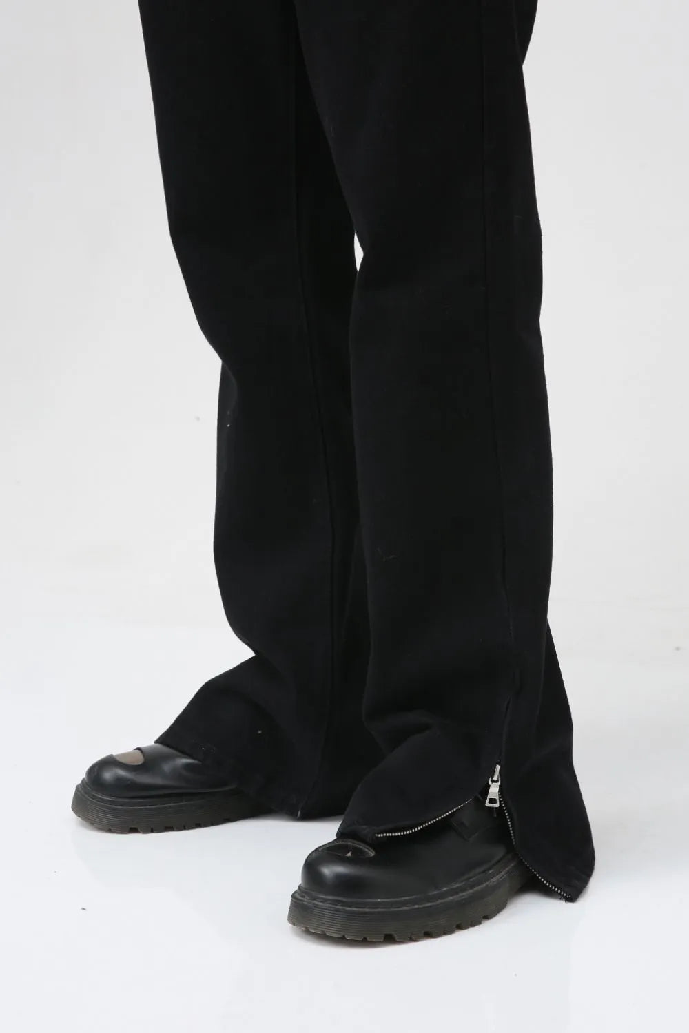 Flared hem denim trousers in dark cotton with zippered ankle detail.