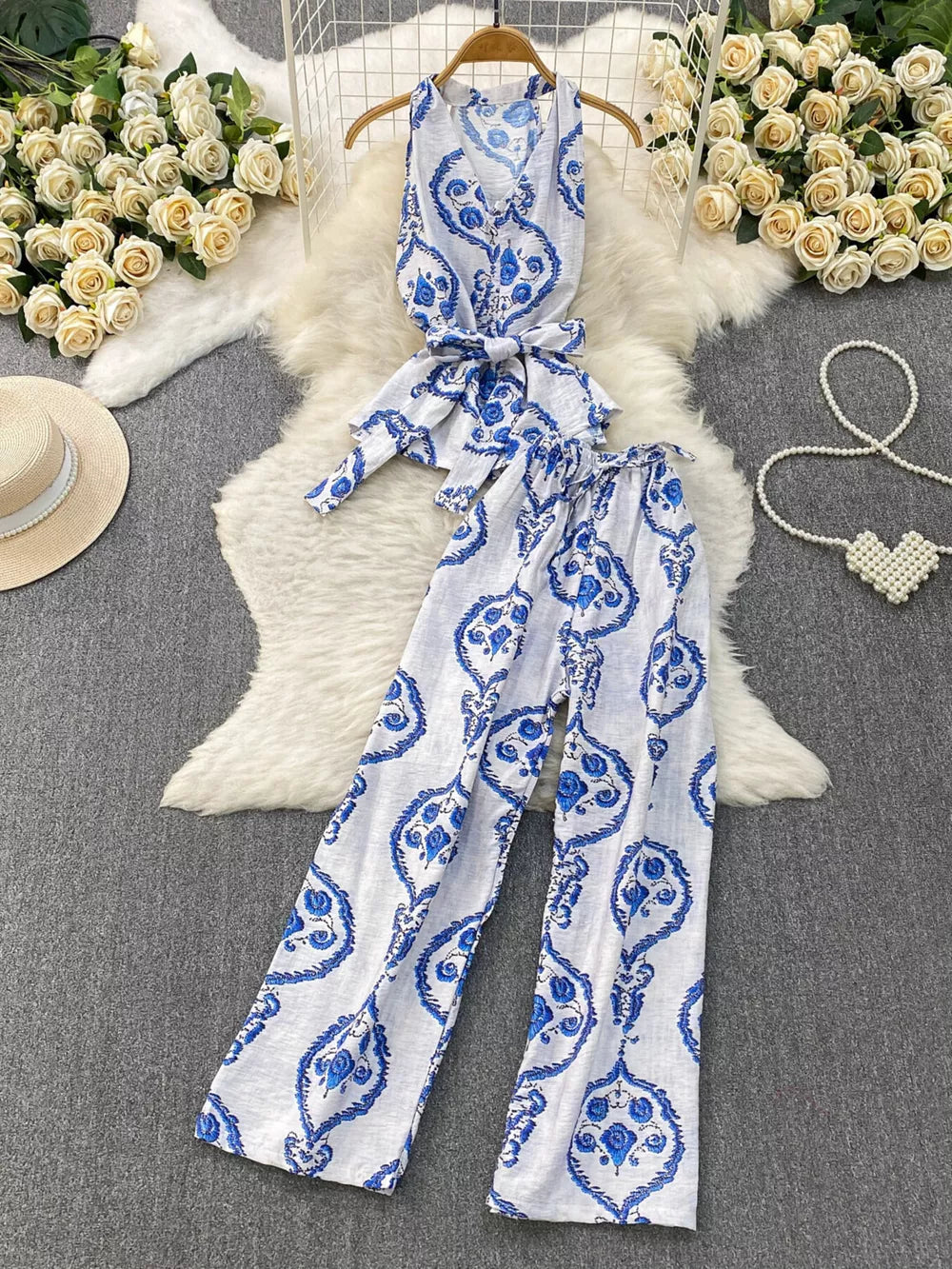Blue and white tropical print halter top and wide leg pants set with belted detail
