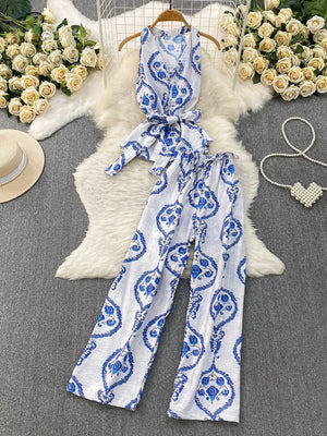 Blue and white tropical print halter top and wide leg pants set with belted detail