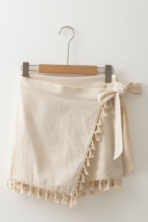 Beige cotton wrap skort with tassel trim and tie waist
