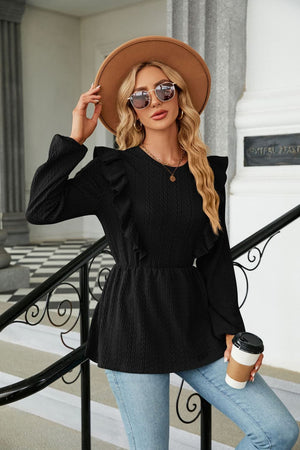 Black textured ruffle peplum blouse with long sleeves and a round neckline.