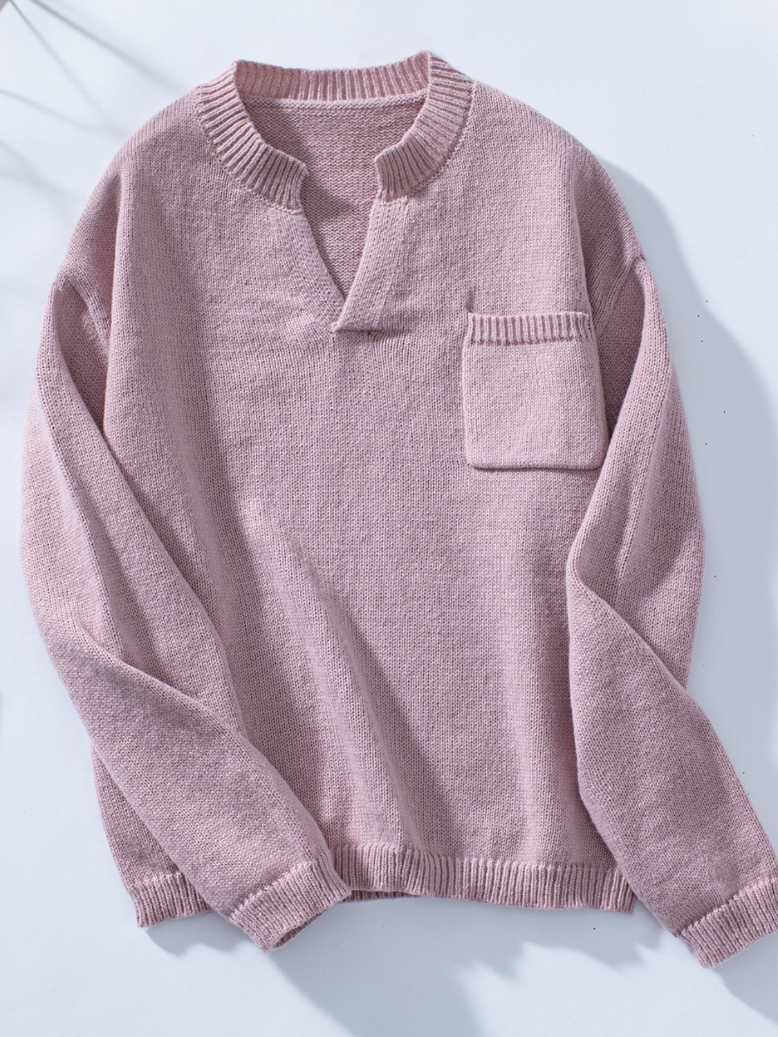 Dusty pink knit sweater with notched neckline and chest pocket.