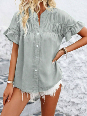 Light gray button-up blouse with gathered yoke and ruffle sleeves.