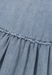 Medium wash denim mini dress with gathered waist and frayed ruffle detail.