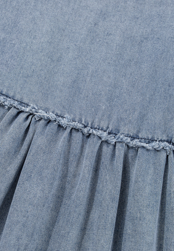 Medium wash denim mini dress with gathered waist and frayed ruffle detail.