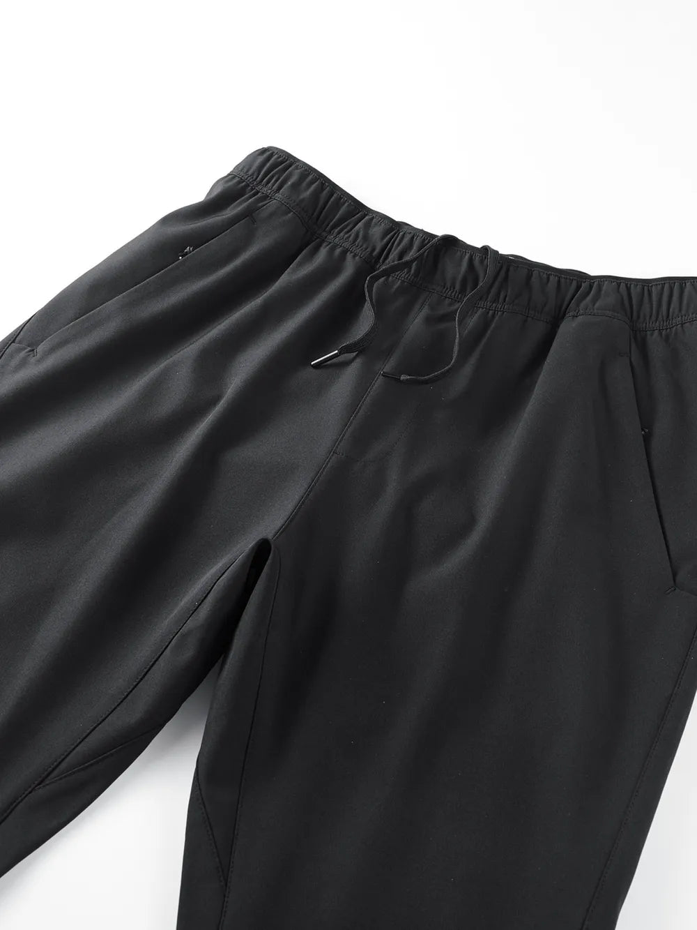 Black men's sweatpants with elastic waistband, drawstring, and side pockets.