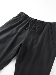 Black men's sweatpants with elastic waistband, drawstring, and side pockets.
