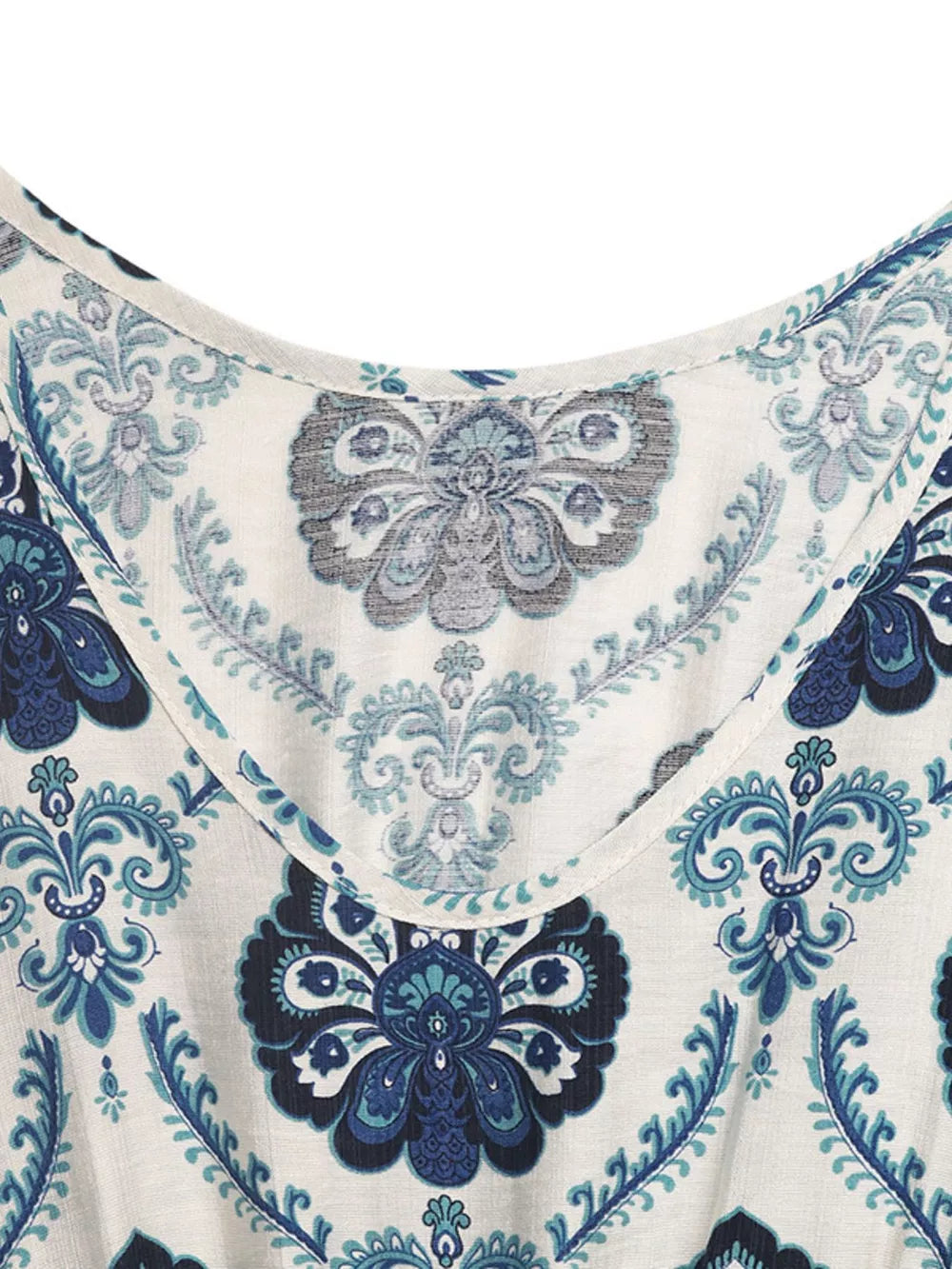 Maxi dress with blue paisley print, scoop neck, and decorative buttons detail.