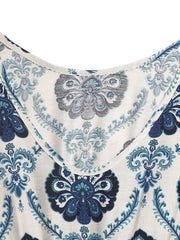 Maxi dress with blue paisley print, scoop neck, and decorative buttons detail.