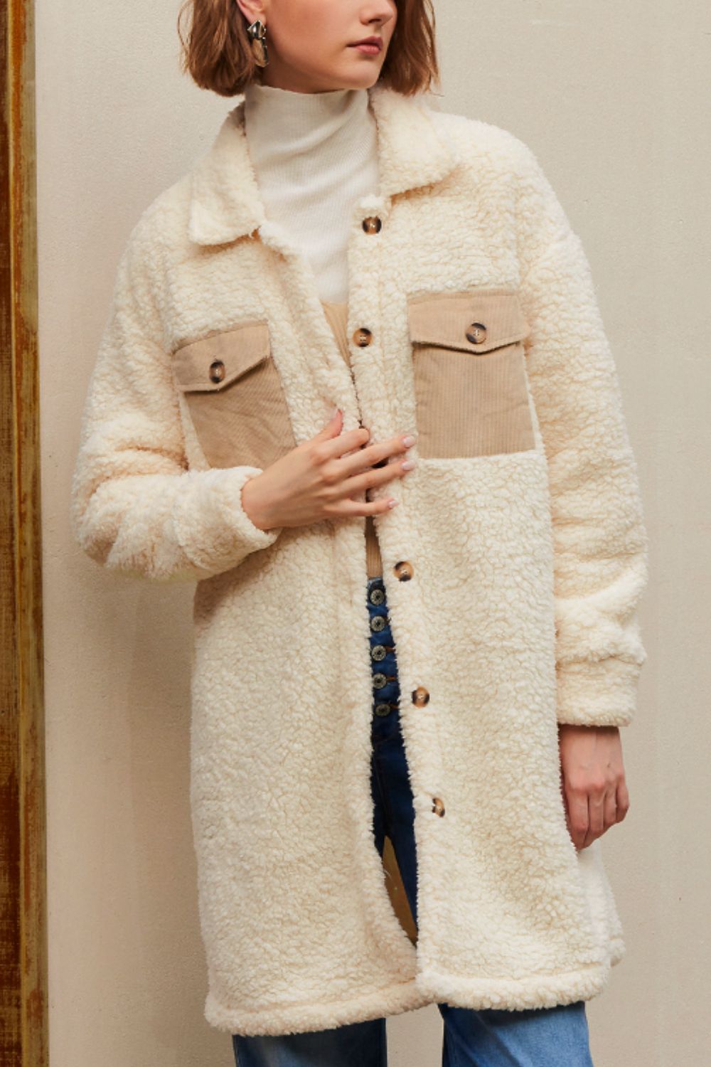 Beige sherpa coat with corduroy patch pockets and button front.