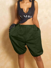 Pleated high-waisted military green shorts with drawstring and balloon leg detail.