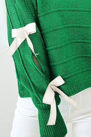 Dark green ribbed knit sweater with bow sleeve detail and cut-out accents.