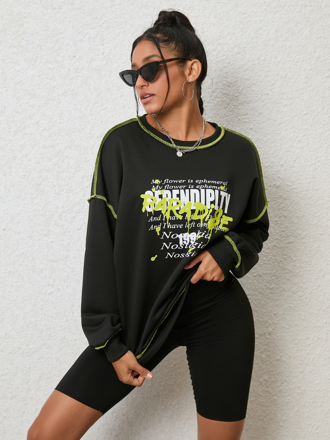 Black graphic sweatshirt with contrast stitching and text detail.