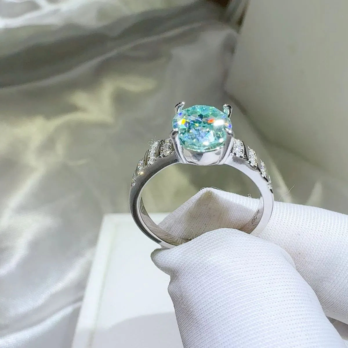 Aquamarine halo oval ring with diamond accents on a silver band.
