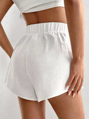 White cotton chino shorts with elastic waistband and relaxed fit.
