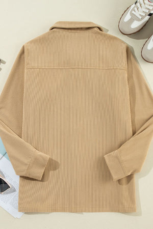 Tan corduroy utility shirt with long sleeves and a button-down collar.