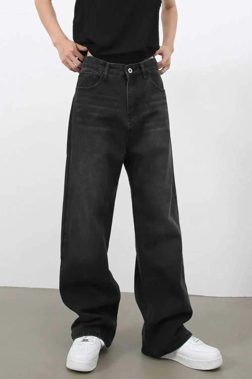Black wide leg denim jeans with a relaxed fit and casual styling.