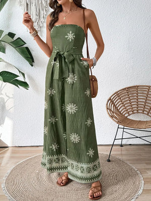 Bandeau jumpsuit in matcha green with white embroidery and wide legs.