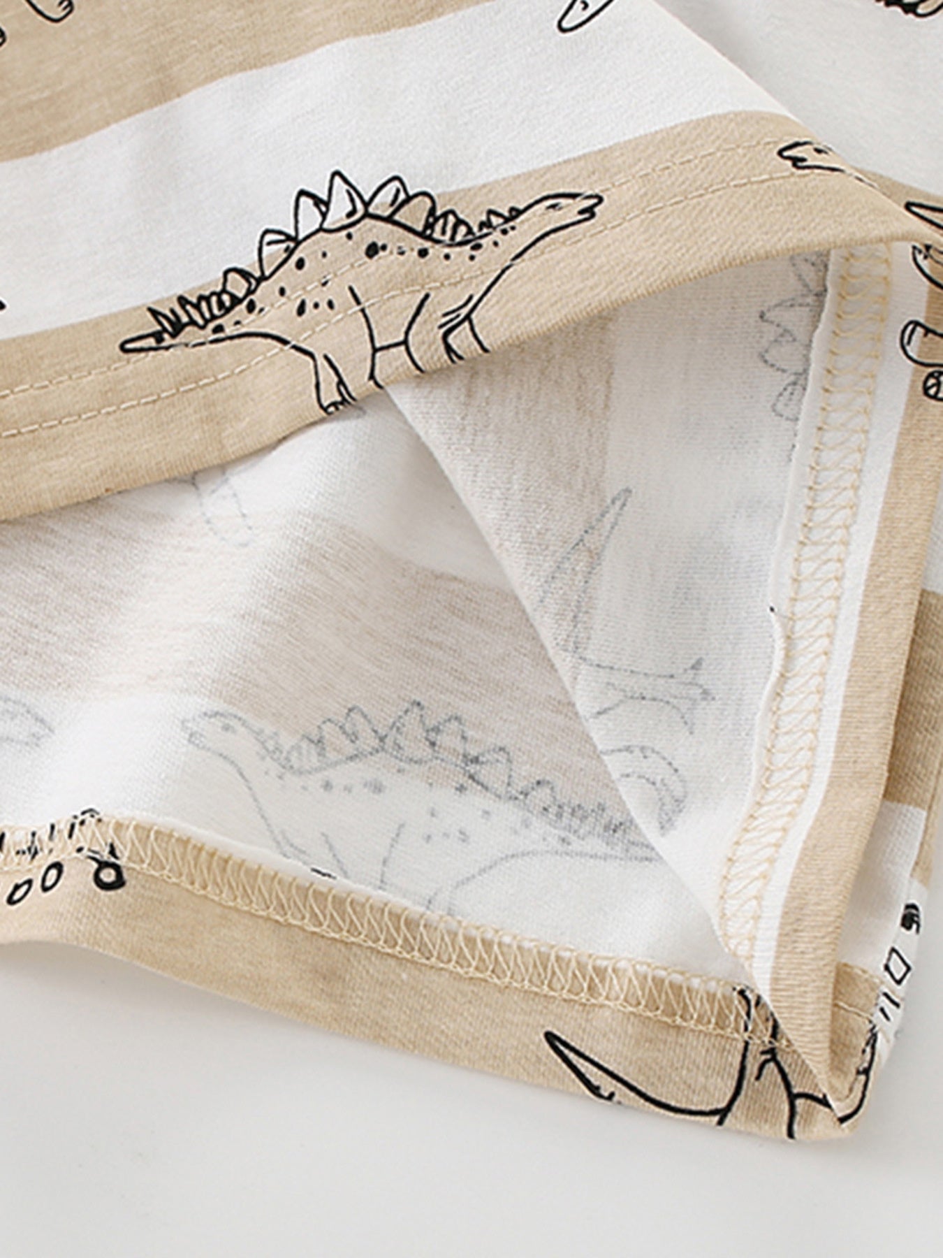 Toddler t-shirt with beige and white stripes and dinosaur print.