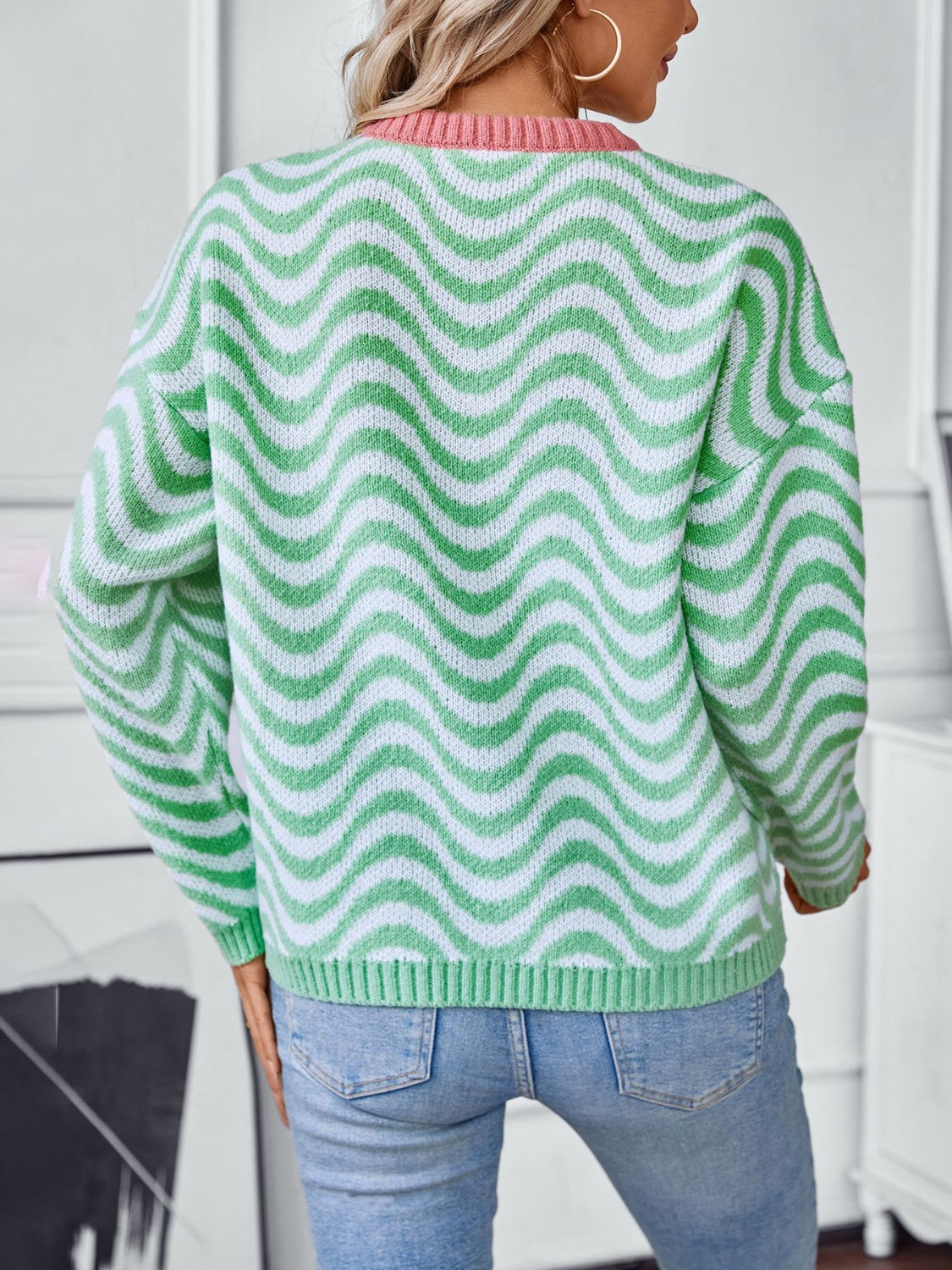 Wavy stripe knit sweater in Gum Leaf green and white with pink contrast collar.