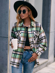 Oversized green plaid flannel shacket with patch pockets and buttoned front.