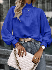 Royal blue textured puff sleeve blouse with smocked neck and cuffs.