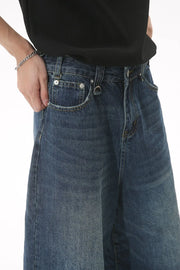 Wide-leg denim culottes in light blue with a relaxed fit and distressed details.