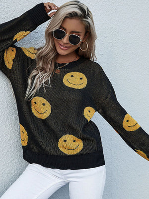 Black jacquard knit sweater with allover yellow smiley faces, crew neck, long sleeves.