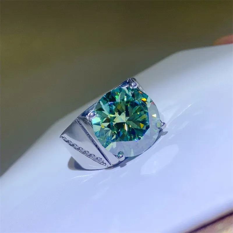 Emerald cut moissanite signet ring in silver with a large green stone.