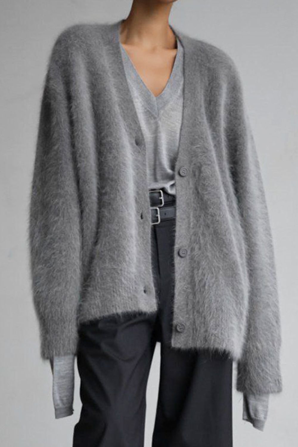 Dark gray angora button cardigan with sculpted sleeves over a v-neck top.